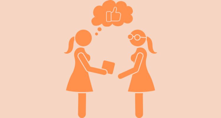 A woman handing another woman a book with a thought bubble with a thumbs up inside of it.