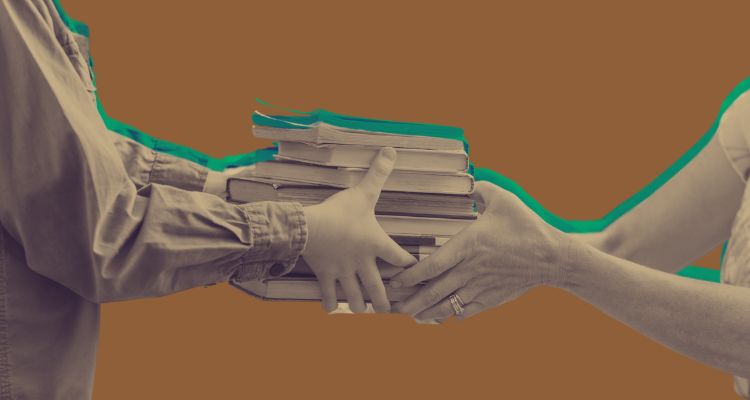Hands trade off books in sepia tones over a brown background.
