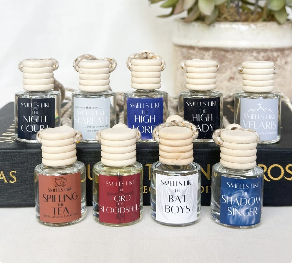 A variety of small vials with wooden tops and twine attached to them so you can hang it in your car. Contains scents like, "Spilling the Tea", "The Night Court", "The High Lady," "Velaris" and "The Bat Boys"