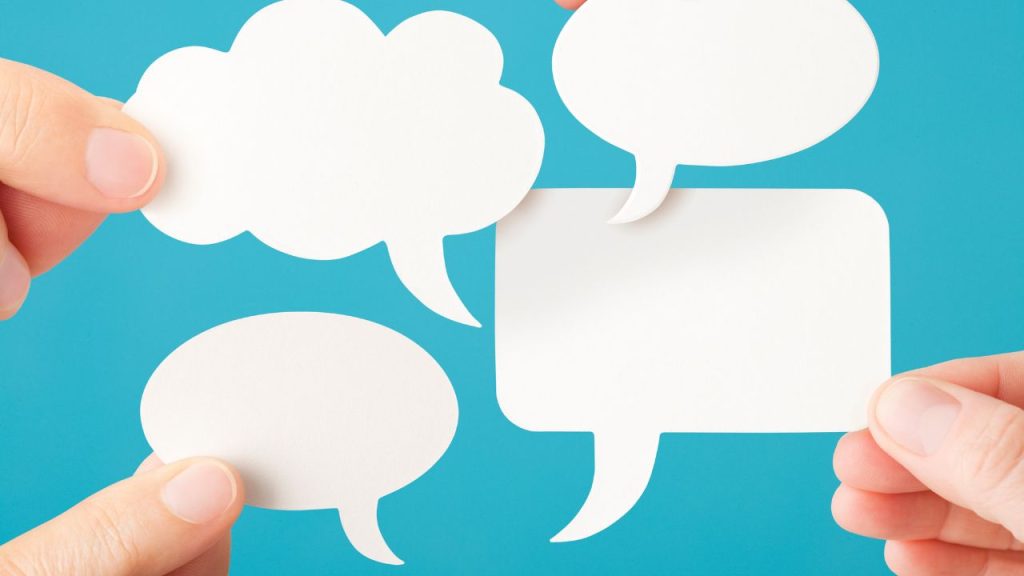 A blue background with four white speech bubbles