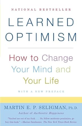 Learned Optimism: How to Change Your Mind and Your Life by Martin E.P. Seligman, a book cover with a white, yellow, and blue background and the words in different colors.