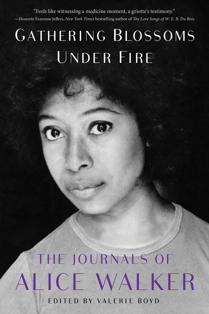 A woman stares straight ahead on the cover of Gathering Blossoms Under Fire.