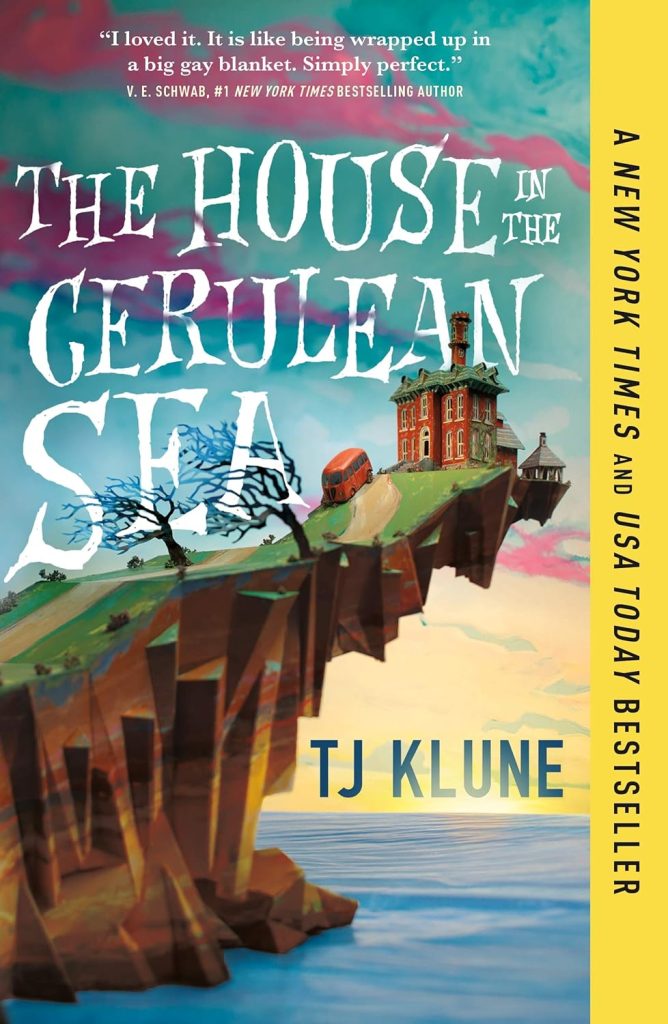 White text reads "The House in the Cerulean Sea" over an illustration of a rocky outcrop at the edge of a blue sea and a rising sun from the horizon. A large orange house stands at the tip of the outcrop, and an orange car is parked nearby on the winding path leading down. Blue text on the horizon reads "T.J. Klune" under a sky with pink and purple clouds.