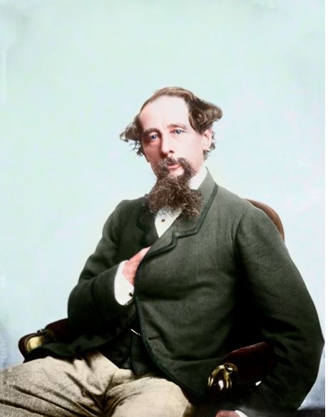 Charles Dickens colorized image of him sitting in leather chair.