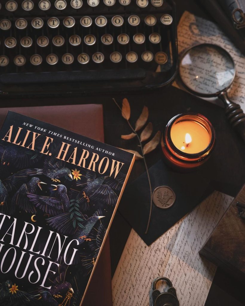 A collection of different items, such as a typewriter, a magnifying glass, a lit candle, a handwritten letter, a coin, a branch, and a book.