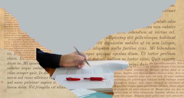 A hand with a pencil, editing writing, is hidden among torn book pages.