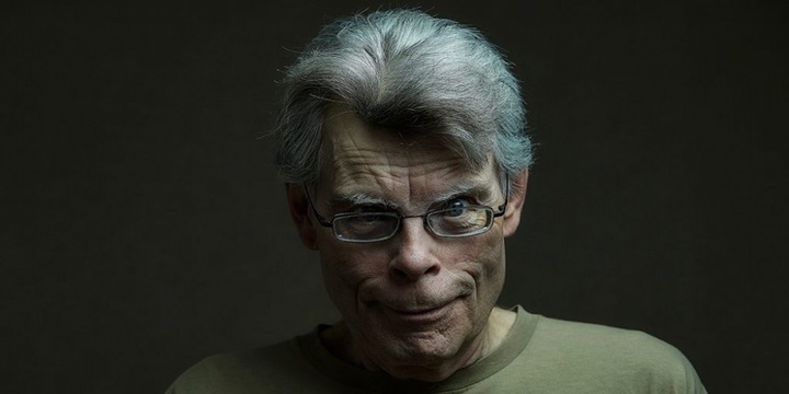 Stephen King, shrouded in shadow and malice.