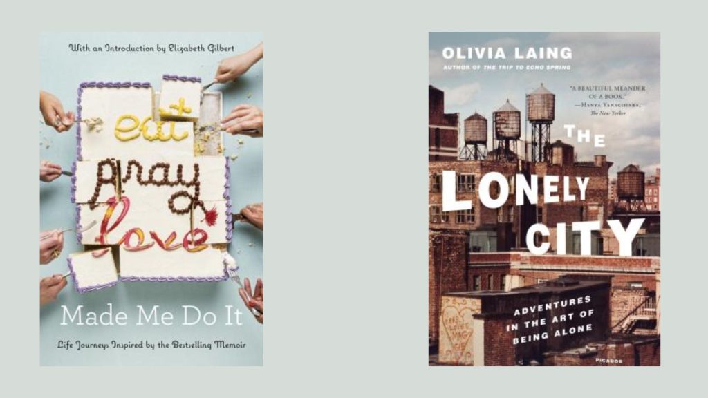 Eat Pray Love spelled out in icing on a white cake being cut and divided by numerous hands. The Lonely City depicts an urban backdrop of buildings and water towers.