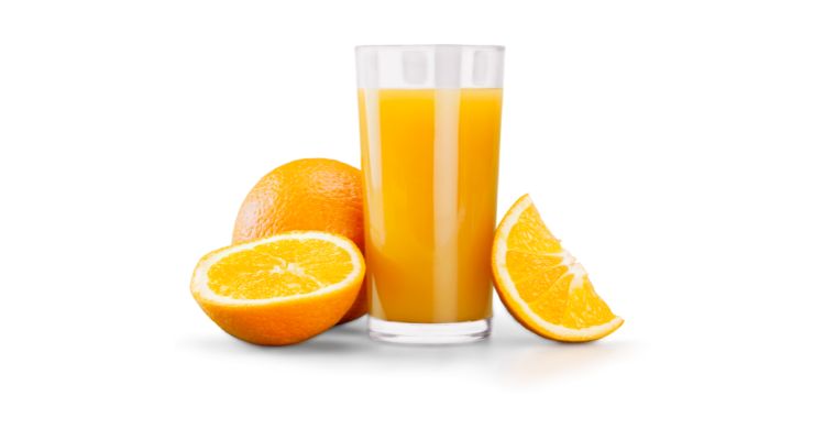 Tall clear glass of orange juice with slices oranges on the side