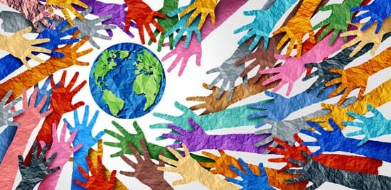 Colorful paper cutouts of hands circle around a paper cutout of the earth.
