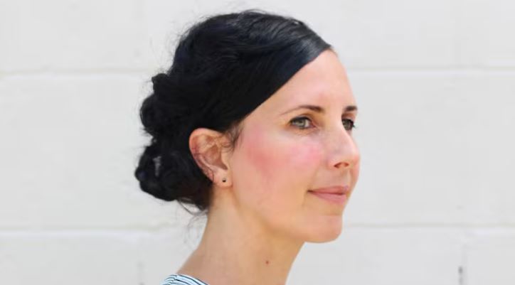 A woman looks off into the distance.