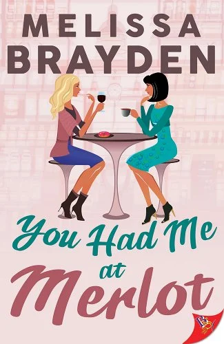 Cover of You Had Me at Merlot with a pink background and two ladies sitting at a high table. One is drinking wine while the other is drinking coffee.