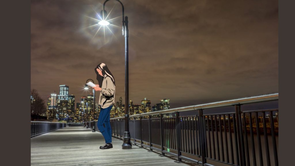 The backdrop of a bustling city shimmers in the distance. A young girl stands reading a book underneath a rather curved streetlamp. Her body is mimicking the streetlamp.