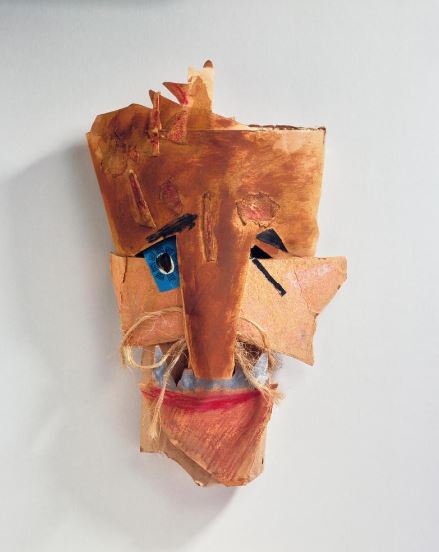 A paper mâché mask with a mustache.