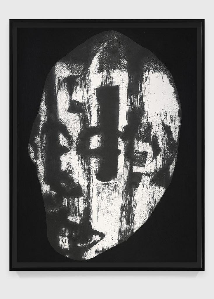 A painting of a face made with black and white ink.