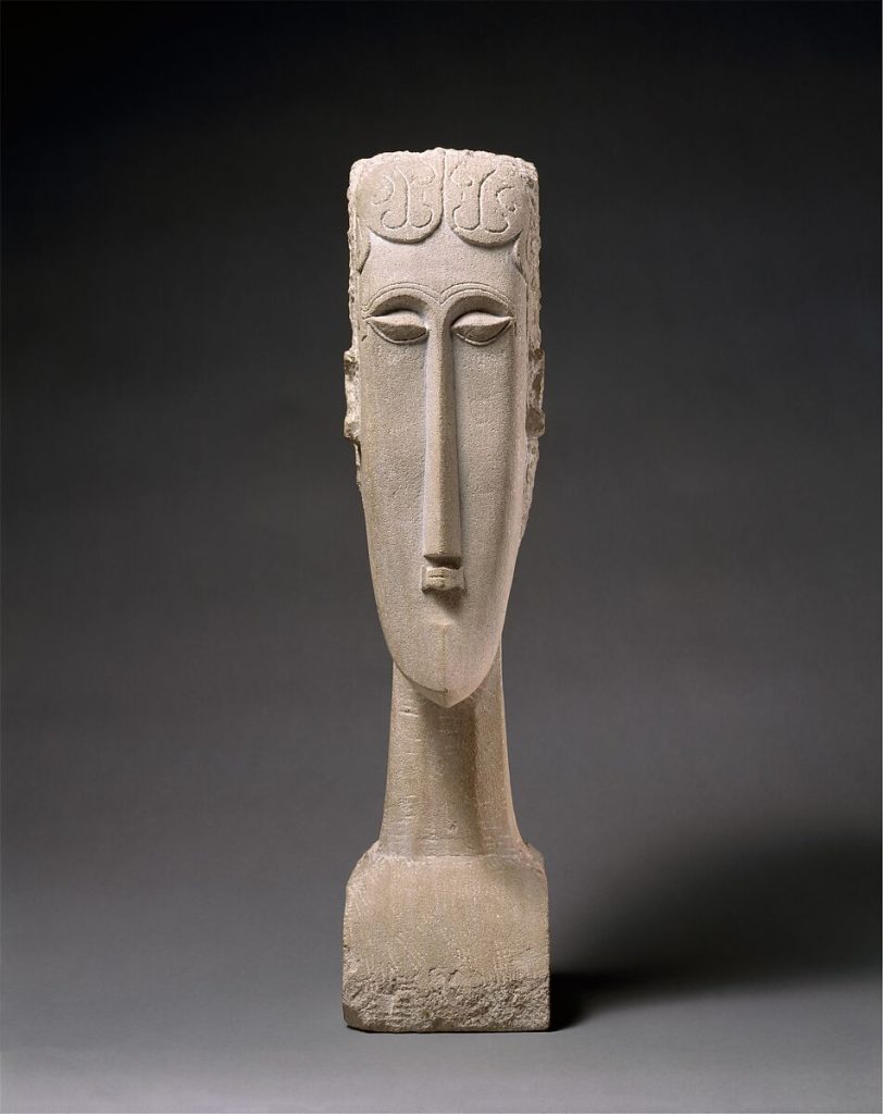 A carved figure of a woman's head.