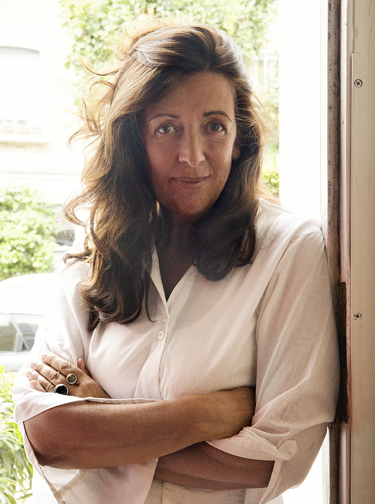 Photo of Louise Doughty, a tan woman with brown hair and a white blouse.