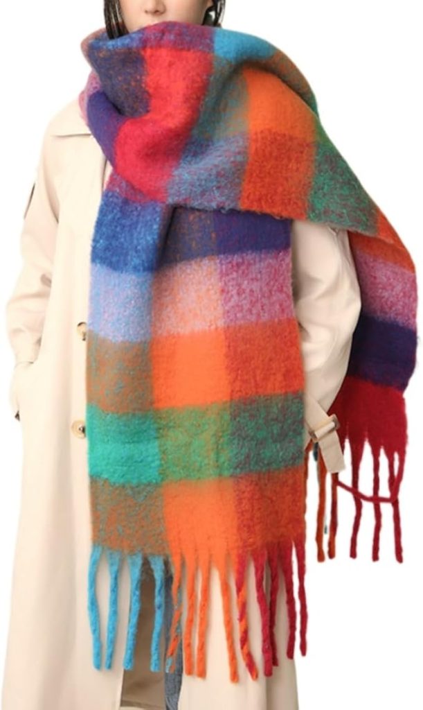A woman wears a large colorful sweater.
