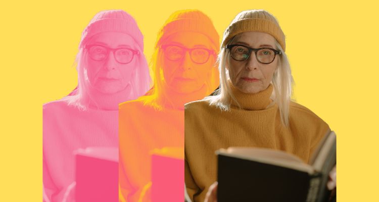 A woman in a yellow turtleneck reading.
