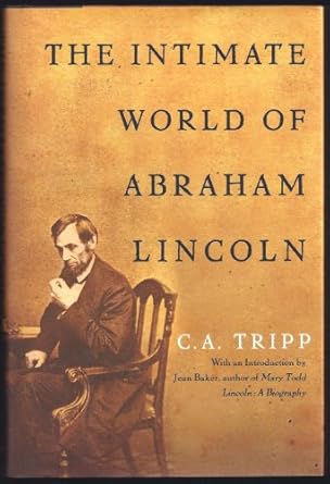 Abraham Lincoln sits at a desk. A beige background sits behind the title in black font.