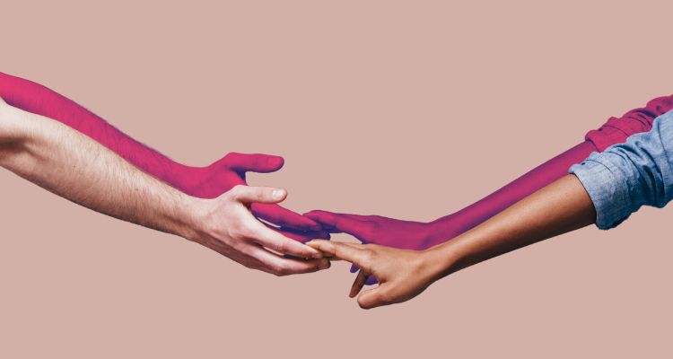 Two hands reach for one another.