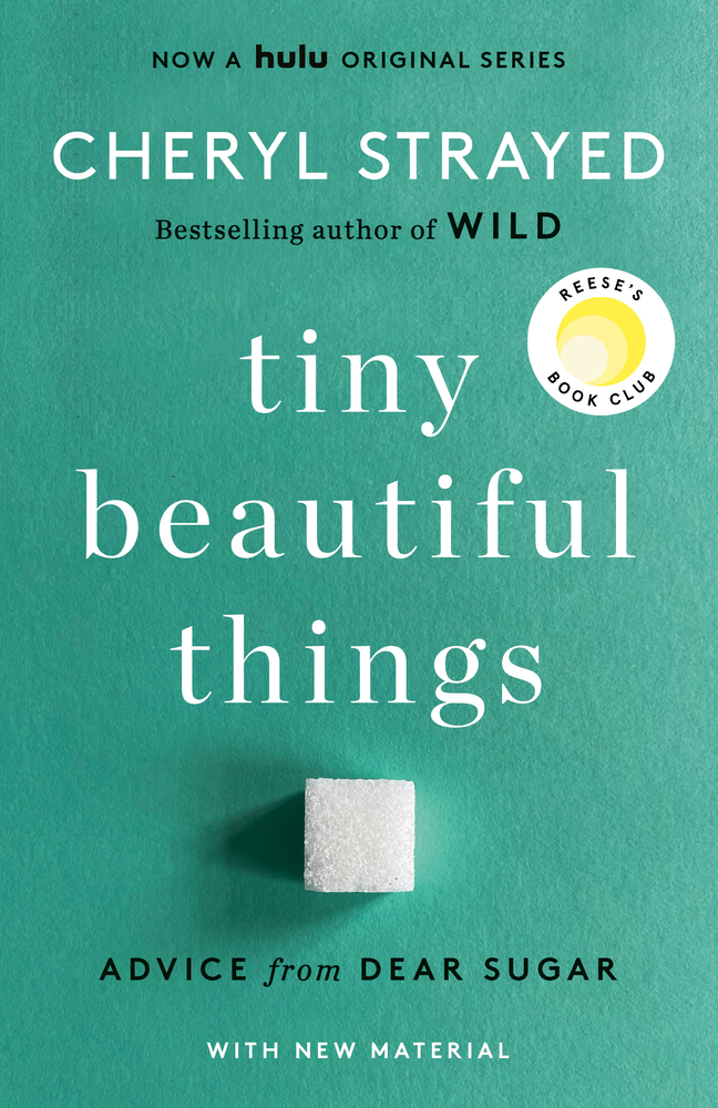A cube of sugar sits along on the cover of tiny beautiful things.