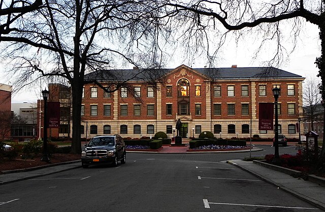 A picture of an HBCU North Carolina Central University. A red brick building with three stories from the street.