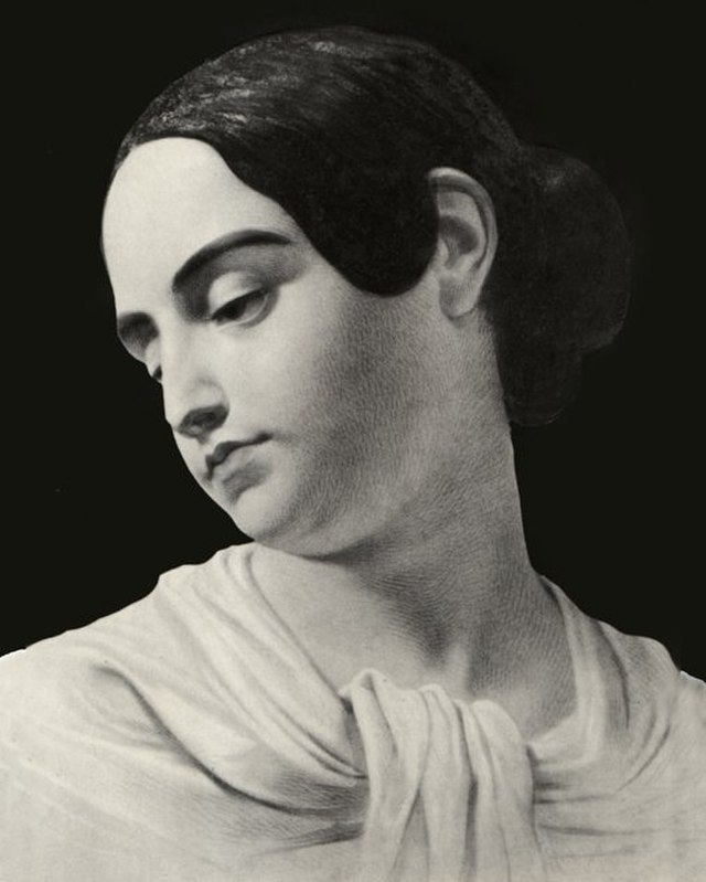 A black and white portrait of Virginia Poe, Poe's wife. She is looking towards the left with her head tilted dressed in a dress.