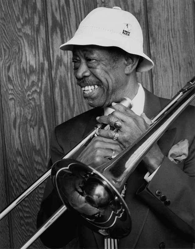 An older Black man holding a trumpet.