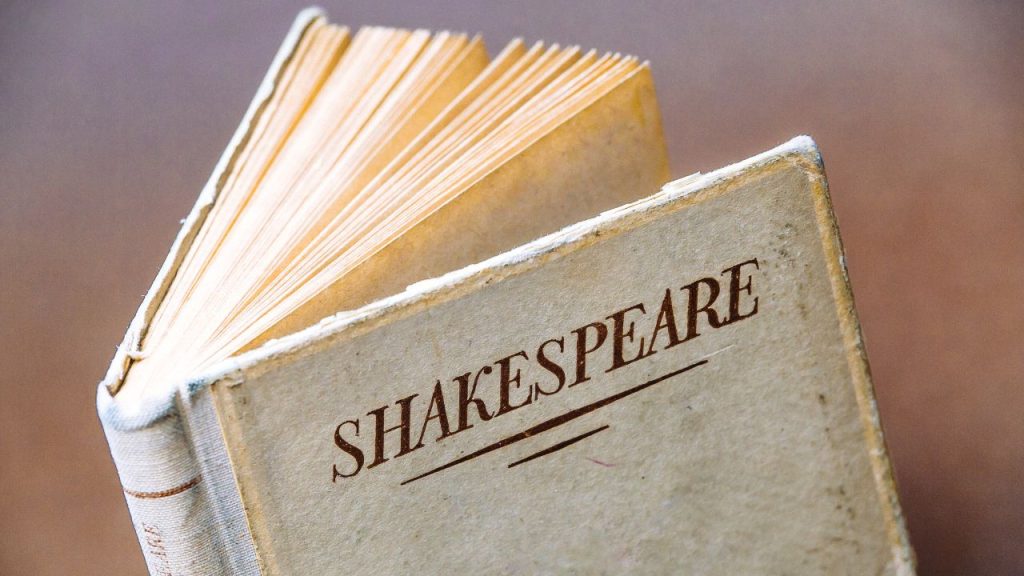 A white book on a brown background says SHAKESPEARE in red text.