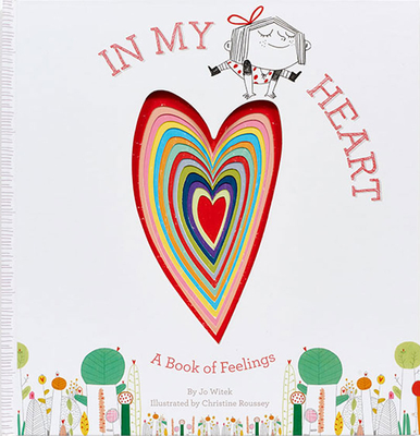 A white background with In My Heart in red text. A girl with a red bow and red polka dot dress balances on top of a multi-colored heart. At the bottom are multi-colored plants and trees.