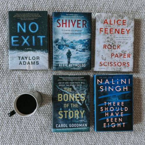 Hannah's book recs by Taylor Adams, Allie Reynolds, Alice Feeney, Nalini Singh, and Carol Goodman next to a cup of coffee.