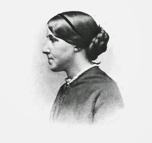 Black-and-white photo of author Louisa May Alcott facing the right against a white background.