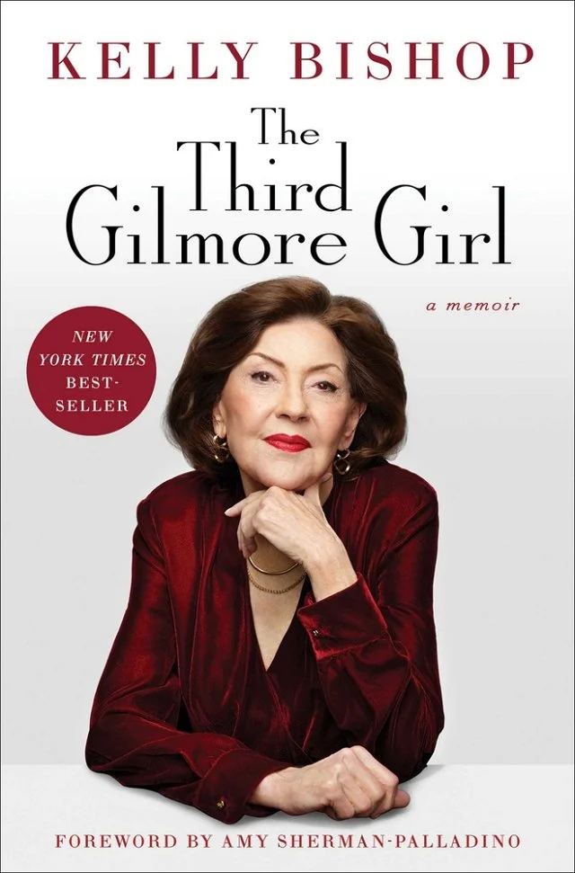 Kelly Bishop in a red blazer with a white background.