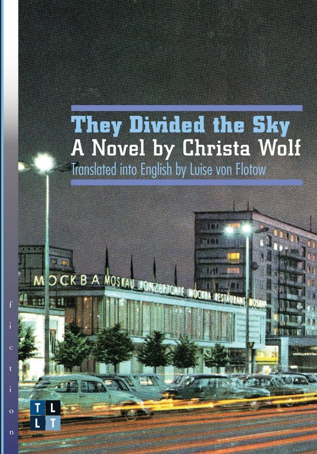 They Divided the Sky by Christa Wolf book cover. A busy city street at nighttime with classic cars lining the road.
