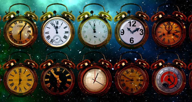 A collection of alarm clocks with assorted faces against a background of outer space.