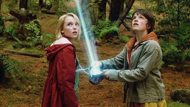 ridge to Terabithia Film Adaptation (02/16/2007), fantasy film image depicting a young boy and girl staring towards a glowing light in the woods.