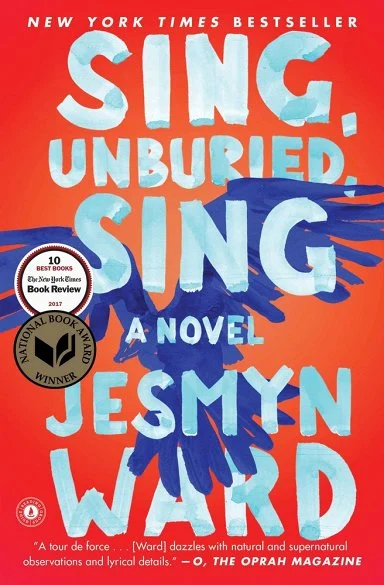 The image shows the book cover of Sing, Unburied, Sing by Jesmyn Ward. The background is a bold red, with blue bird wings prominently extending from the sides. 