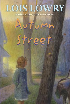 Part of a neighborhood. We see leafless trees, part of a white house, and part of a parked car. A little girl with blonde hair and a blue coat looks behind her to a forest in the distance. Autumn Street in orange lettering.