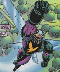 HORNET (in the full suit and cowl, with purple and green accents and a yellow hornet emblem) with his left fist in the air. He is flying above the city.