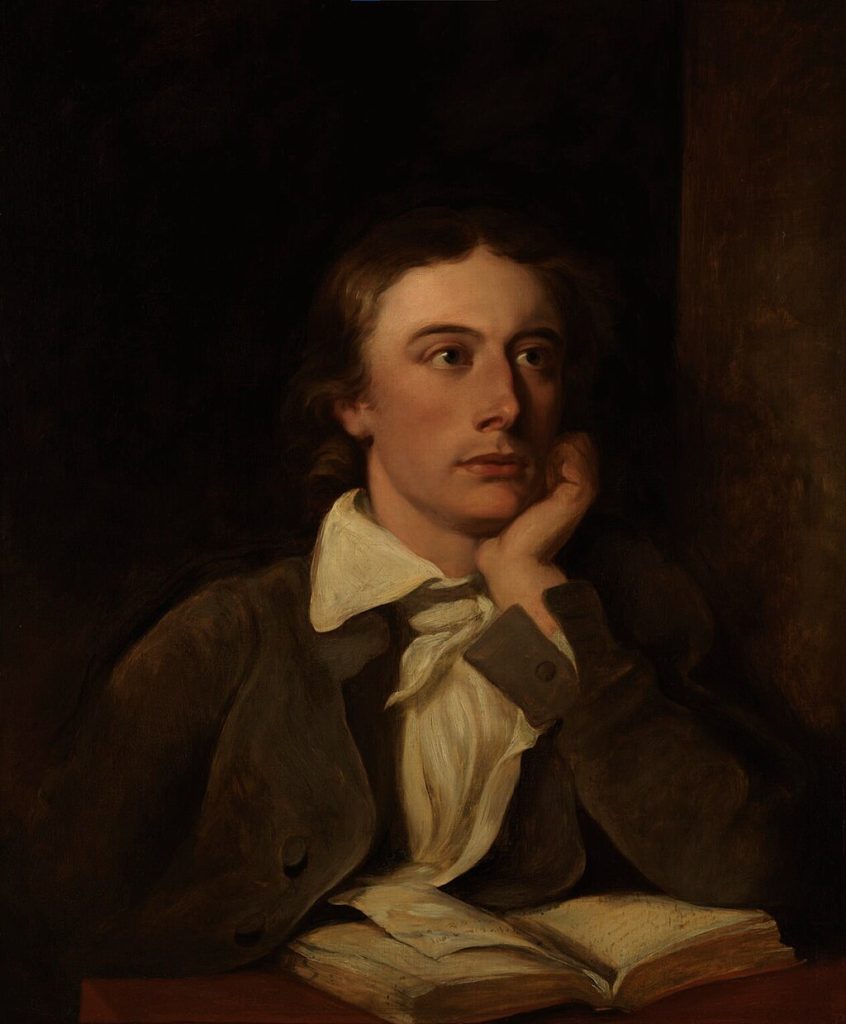 A portrait of John Keats. He wears a white blouse and brown coat and sits with his chin on his palm.