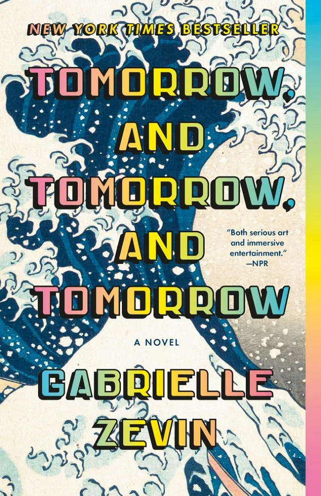 Tomorrow, and Tomorrow, and Tomorrow book cover with rainbow gradient text and a wave illustration in the background.