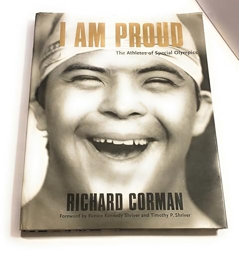 I Am Proud: The Athletes of Special Olympics. A cover of a young boy with down syndrome and a swim cap on as he smiles.