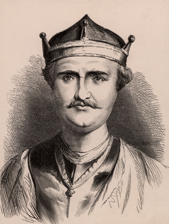 A drawn depiction of William the Conqueror, the first Norman King of England. He is wearing a crown and has short hair that peaks out underneath. He has a stern expression and a mustache. He is wearing fine clothes and a necklace.