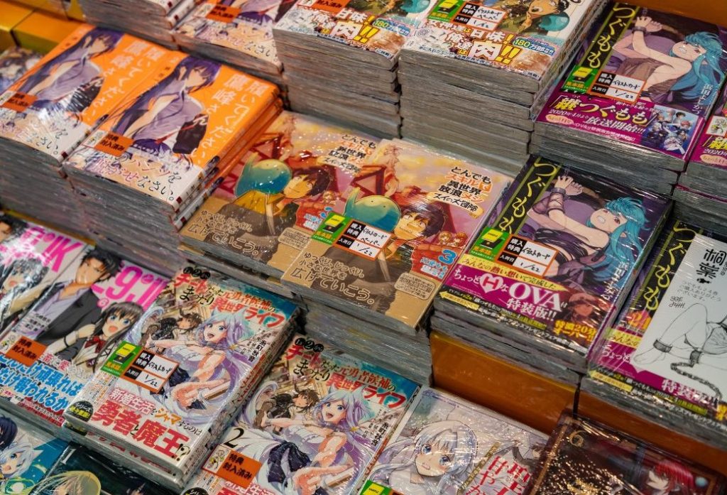 Stacks of magazines with manga in them, all of various genres