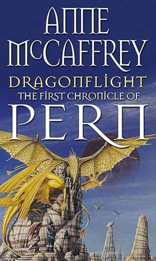 The book cover of Dragonflight, the first novel in The Dragonriders of Pern series by Anne McCaffrey. It features a majestic golden dragon with large, outstretched wings flying above a rocky landscape. A rider is seen on its back, set against a sky with a distant planet in the background.