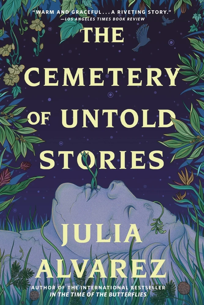 The book cover for The Cemetery of Untold Stories. A worn statue of a woman's head lies in a field of grass, with plants growing out of her mouth. Plants frame the book cover, and the background is a dark blue night sky with two doves flying in the top right corner. The Cemetery of Untold Stories is in pale yellow lettering.