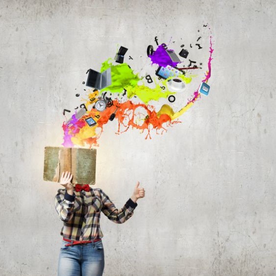 Someone covering their face with a book and giving a thumbs up. Symbols such as letters, a coffee cup, a tablet, and more are coming from the book, as well as pink, orange, yellow, green, purple, and blue splashes.