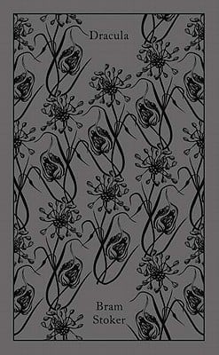 The book cover for Dracula. A gray background with black flowers. Dracula is in black lettering.