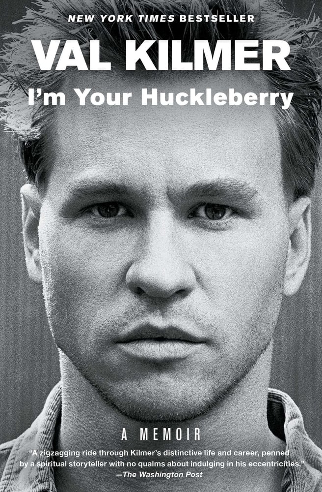 The book cover for I'm Your Huckleberry. A black and white photo of Val Kilmer's face. I'm Your Huckleberry is in white lettering.